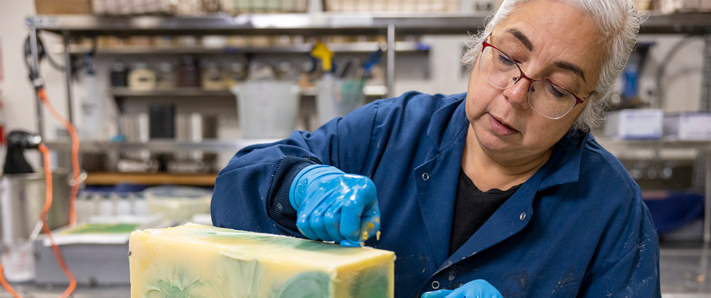 Soap maker and business owner making soap.