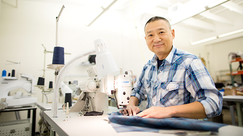 man working on textiles